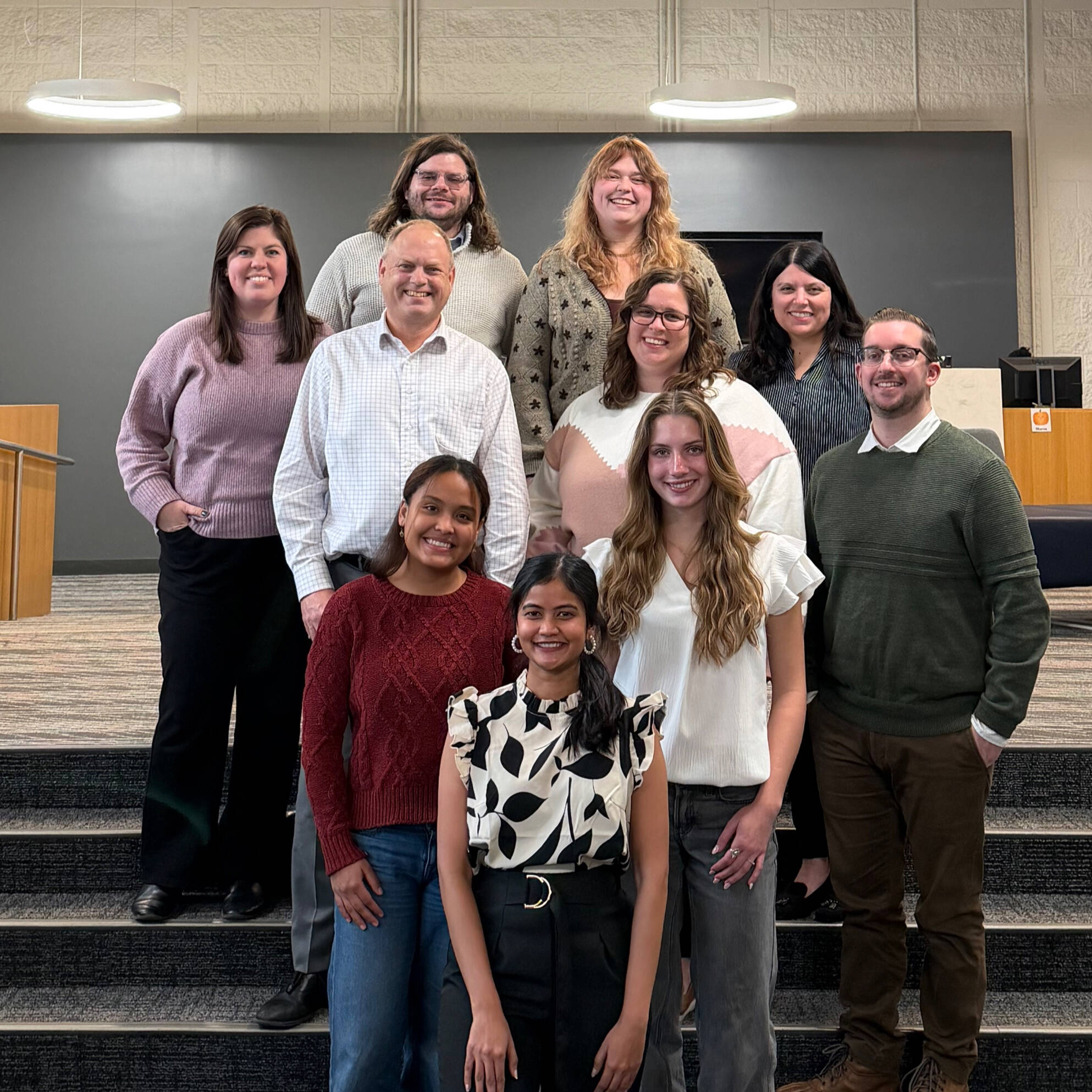 PCE advising center staff posing in the innovation design center lobby